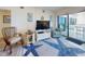 Cozy living area with TV, balcony access, and views at 4175 S Atlantic Ave # 4110, New Smyrna Beach, FL 32169