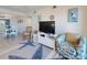 Living room with TV, comfortable seating, and a partial view of the dining area at 4175 S Atlantic Ave # 4110, New Smyrna Beach, FL 32169