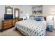 Comfortable main bedroom featuring wicker furniture, nautical art, and a queen sized bed at 4175 S Atlantic Ave # 4110, New Smyrna Beach, FL 32169
