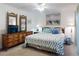 Cozy main bedroom with a seahorse patterned bedspread and wicker furniture at 4175 S Atlantic Ave # 4110, New Smyrna Beach, FL 32169
