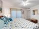 Seahorse themed bedding in this bedroom that features a rattan stool and a lamp at 4175 S Atlantic Ave # 4110, New Smyrna Beach, FL 32169