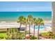 Beautiful ocean view with palm trees and a refreshing pool, creating a vacation oasis at 4175 S Atlantic Ave # 4110, New Smyrna Beach, FL 32169