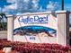 Castle Reef Condominiums sign with coral reef graphic and address 4175, surrounded by red plants at 4175 S Atlantic Ave # 4110, New Smyrna Beach, FL 32169
