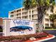 Castle Reef Condominiums sign in front of the building, highlighting address and coral reef design at 4175 S Atlantic Ave # 4110, New Smyrna Beach, FL 32169