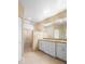 Elegant bathroom features dual sinks, a large shower with stone accents, and neutral decor at 438 Bouchelle Dr # 105, New Smyrna Beach, FL 32169
