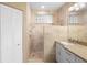 Beautiful bathroom with a walk-in shower featuring glass block window and a single sink vanity at 438 Bouchelle Dr # 105, New Smyrna Beach, FL 32169