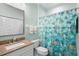 Bright bathroom with a vanity, toilet, and a shower featuring a playful fish-themed curtain at 438 Bouchelle Dr # 105, New Smyrna Beach, FL 32169