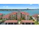 Beautiful multi-story building with a red tile roof and lush landscaping, set against a waterfront backdrop at 438 Bouchelle Dr # 105, New Smyrna Beach, FL 32169