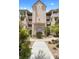 Inviting entrance with lush landscaping, a fountain, and classic architectural details with multiple stories at 438 Bouchelle Dr # 105, New Smyrna Beach, FL 32169