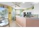 Well-lit kitchen with stainless steel appliances, granite countertop and breakfast bar at 438 Bouchelle Dr # 105, New Smyrna Beach, FL 32169