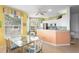 Bright eat-in kitchen features modern white cabinets, stainless steel appliances, and breakfast nook at 438 Bouchelle Dr # 105, New Smyrna Beach, FL 32169