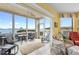 Inviting sunroom with tile floors, water views, comfortable seating, and seamless indoor/outdoor living at 438 Bouchelle Dr # 105, New Smyrna Beach, FL 32169