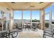 Relaxing lanai with comfortable seating and a ceiling fan, offering stunning waterfront views at 438 Bouchelle Dr # 105, New Smyrna Beach, FL 32169