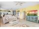 Spacious living room showcasing an open floor plan, a decorative hutch, and a mounted flatscreen TV at 438 Bouchelle Dr # 105, New Smyrna Beach, FL 32169