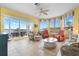 Bright and spacious living room with tile flooring, comfortable seating, and panoramic water views at 438 Bouchelle Dr # 105, New Smyrna Beach, FL 32169