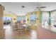 Open concept living space with tile floors, ceiling fan, waterfront views, and dining area at 438 Bouchelle Dr # 105, New Smyrna Beach, FL 32169