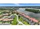 Gorgeous aerial view of waterfront condo community with lush greenery and a tranquil waterway at 454 Bouchelle Dr # 102, New Smyrna Beach, FL 32169
