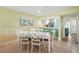 Charming dining area with seating for six next to an open bar and kitchen at 454 Bouchelle Dr # 102, New Smyrna Beach, FL 32169