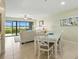 Inviting dining area flows into a comfortable living room with scenic views at 454 Bouchelle Dr # 102, New Smyrna Beach, FL 32169