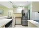 Bright kitchen featuring stainless steel appliances and a large basin sink at 454 Bouchelle Dr # 102, New Smyrna Beach, FL 32169