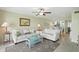 Comfortable living area with a fan, neutral decor, and an open flow to the kitchen at 454 Bouchelle Dr # 102, New Smyrna Beach, FL 32169
