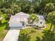 Aerial view of a beautiful home with lush landscaping, a well-manicured lawn, and a spacious driveway at 4623 Secret River Trl, Port Orange, FL 32129