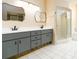 Bright bathroom features gray double vanity with black fixtures, and a glass shower at 4623 Secret River Trl, Port Orange, FL 32129