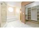 Well-lit bathroom with soaking tub, shower, walk-in closet, and tile floors at 4623 Secret River Trl, Port Orange, FL 32129