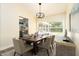 Comfortable dining area with ample seating, modern decor, and an open view to the kitchen at 4623 Secret River Trl, Port Orange, FL 32129
