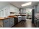 Charming kitchen featuring gray cabinetry, butcher block countertops, and stainless steel appliances at 4623 Secret River Trl, Port Orange, FL 32129