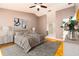Spacious main bedroom features a ceiling fan, a dresser, and an attached bathroom at 4623 Secret River Trl, Port Orange, FL 32129