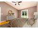 Comfortable bedroom with wood floors, ceiling fan, dresser, and sliding glass door at 4623 Secret River Trl, Port Orange, FL 32129