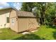 Storage shed offers additional storage space and matches the home's exterior at 4623 Secret River Trl, Port Orange, FL 32129