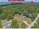 Aerial view of the property and the surrounding neighborhood near De Leon Springs State Park at 5060 Audubon Ave, De Leon Springs, FL 32130