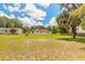 Large backyard featuring a well-maintained lawn and a view of the home's rear exterior at 5060 Audubon Ave, De Leon Springs, FL 32130
