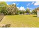 Expansive backyard with lush green grass and mature trees creating a private oasis at 5060 Audubon Ave, De Leon Springs, FL 32130