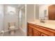 Bright bathroom with white fixtures, wood vanity, and a shower-tub combination at 5060 Audubon Ave, De Leon Springs, FL 32130