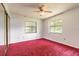 Bedroom with two windows and a sliding mirror closet door at 5060 Audubon Ave, De Leon Springs, FL 32130