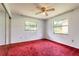 Bedroom with two windows and a mirrored sliding door closet at 5060 Audubon Ave, De Leon Springs, FL 32130