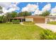 Single story home with a two car garage, screened-in porch and a well manicured lawn at 5060 Audubon Ave, De Leon Springs, FL 32130