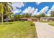 Charming home with a well-kept lawn, a paved driveway, and mature landscaping at 5060 Audubon Ave, De Leon Springs, FL 32130