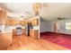 Open concept kitchen with laminate flooring, stainless steel appliances, and plenty of cabinet space at 5060 Audubon Ave, De Leon Springs, FL 32130