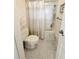 Cozy bathroom with a toilet, shower with curtain, and decorative tiling at 51 Fore Dr, New Smyrna Beach, FL 32168