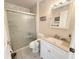 Bright bathroom featuring a tiled walk-in shower and a white vanity with ample storage at 51 Fore Dr, New Smyrna Beach, FL 32168