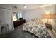 Well-lit bedroom with floral bedding, ceiling fan, new floors and neutral-colored walls at 51 Fore Dr, New Smyrna Beach, FL 32168