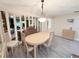 Dining room boasts a large dining table, mirror accents, and crown molding at 51 Fore Dr, New Smyrna Beach, FL 32168