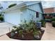 Exterior of home featuring a well-kept lawn, tidy landscaping, and a neutral paint scheme at 51 Fore Dr, New Smyrna Beach, FL 32168