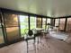 Enclosed Florida room with views of the water, features a cafe table set and extra sitting area at 51 Fore Dr, New Smyrna Beach, FL 32168