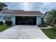 Spacious two-car garage with ample storage and direct access to the home and a concrete driveway at 51 Fore Dr, New Smyrna Beach, FL 32168