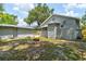 The backyard features a stone textured home and a fire pit, perfect for outdoor gatherings at 514 Mary Ave, New Smyrna Beach, FL 32168
